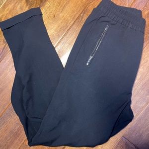 Black pleaded chinos